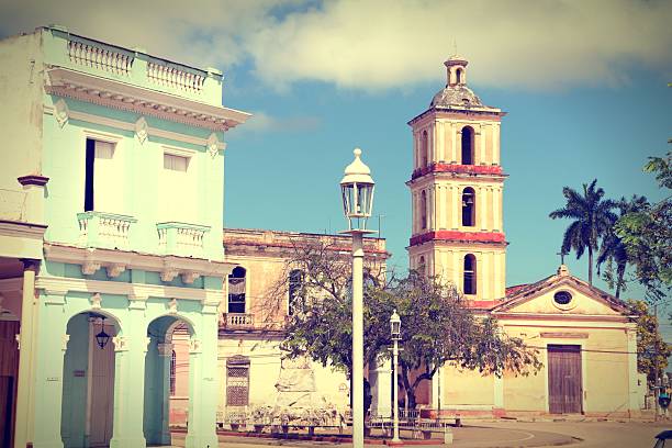 Remedios, Cuba - main square palm trees and church. Cross processed color tone - retro style filtered image.