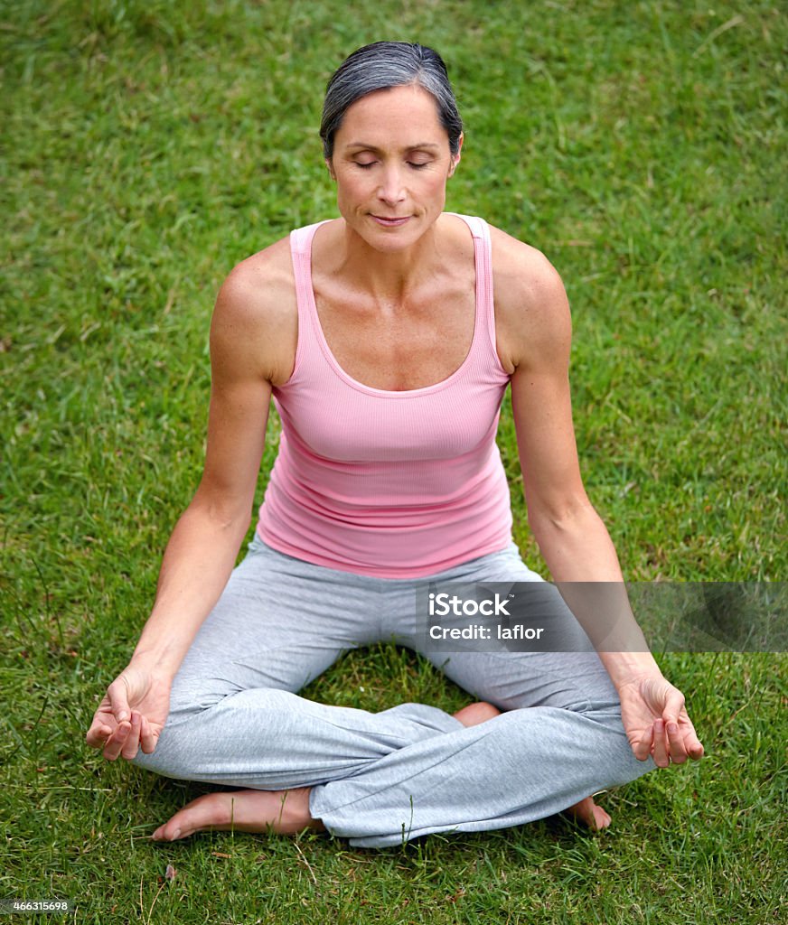 Little bit of zen goes a long way Shot of an attractive mature woman practicing yoga in the lotus positionhttp://195.154.178.81/DATA/istock_collage/a4/shoots/785184.jpg 2015 Stock Photo