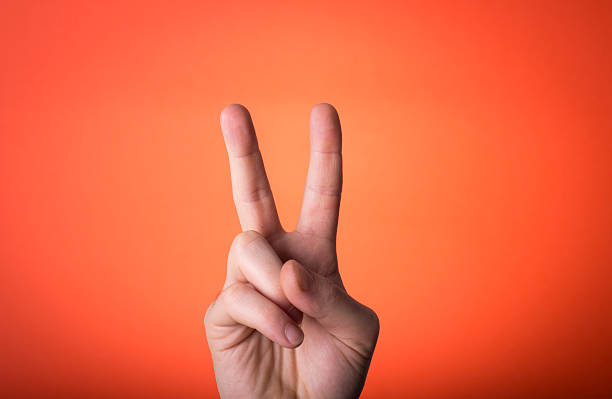 istock man's hand isolated on orange red background 466317651