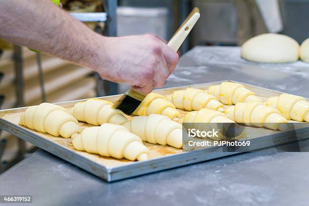 Baker Putting Yolk On Croissants Stock Photo - Download Image Now - 2015, Activity, Adult