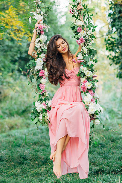 Beautiful young girl on a swing