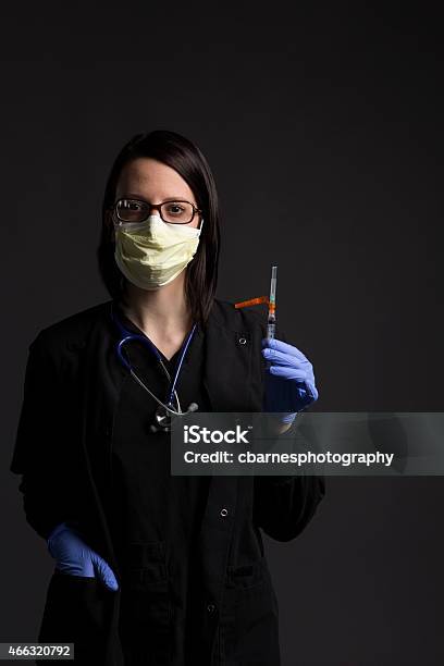 Surgical Mask Wearing Medical Nurse With Healthcare Medicine Vaccine Syringe Stock Photo - Download Image Now