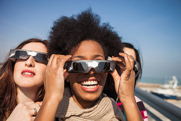 Group of friends preparing to look a solar eclipse