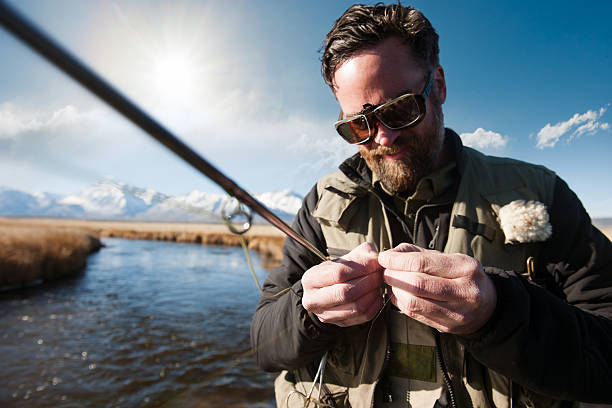 Fisherman With Magnifying Glasses stock photo