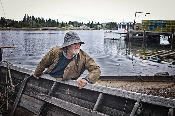 istock Fisherman Standing Near a Dory, Mahone Bay, Nova Scotia. 466326284