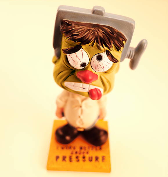 istock Man Under Pressure and Vice on His Head 466327512