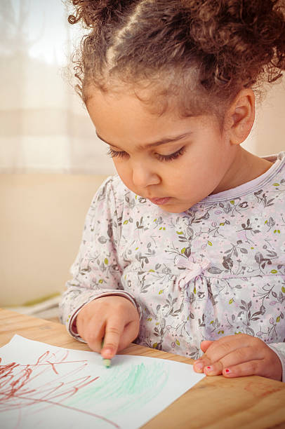 istock Child concentrating on drawing at home 466331296