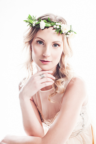 Beautiful young woman with flower wreath in her hair.