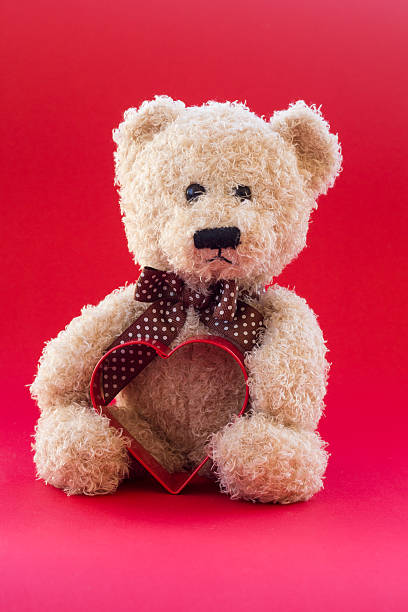 istock Cute teddy bear holding a heart 466331727