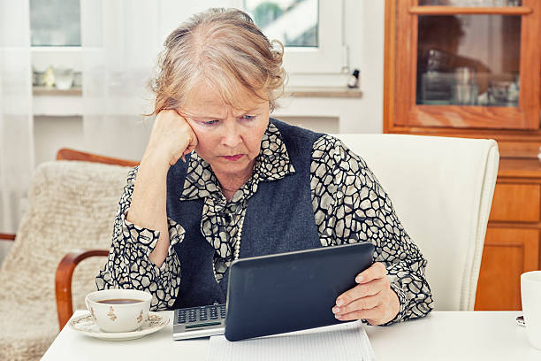 istock old fashioned senior woman calculating finances with digital tablet 466332257