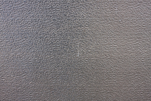 This image shows a textured silver metal surface. Good for a background.
