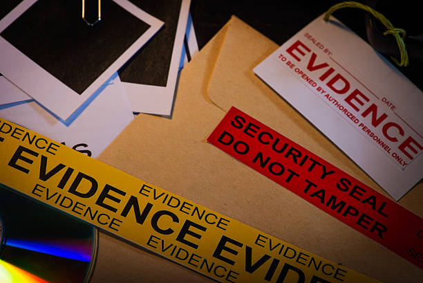 Classified files Close up shot of police desk with crime case records containing blank photos, crime scene information sheet, cd rom, and police reports. evidence stock pictures, royalty-free photos & images