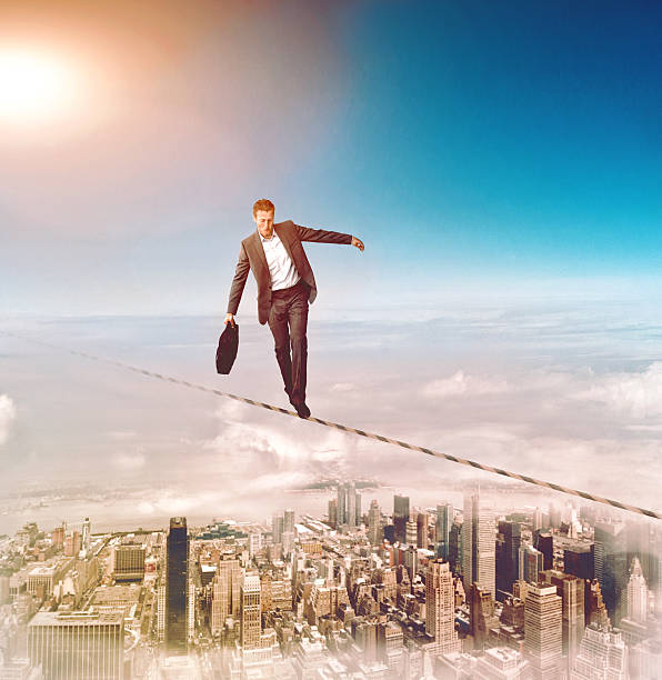 istock Man walks on a wire and almost loses his balance 466333728