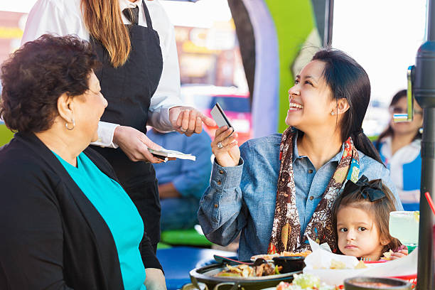 istock Customer paying for meal at Tex-Mex restaurant with credit card 466333784