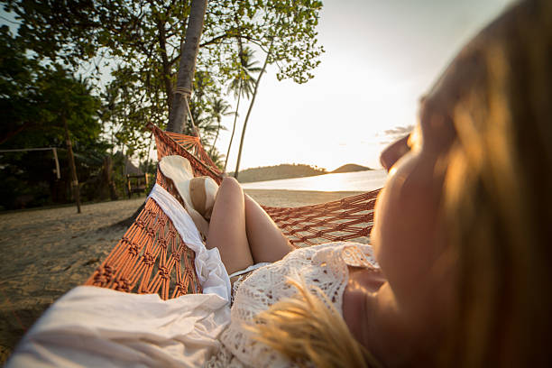 istock Rare view of woman on hammock-Sunset on beach 466333934