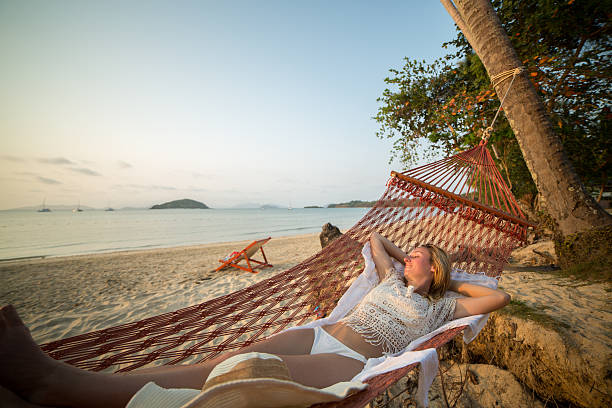 istock Woman on hammock at tropical beach 466333942