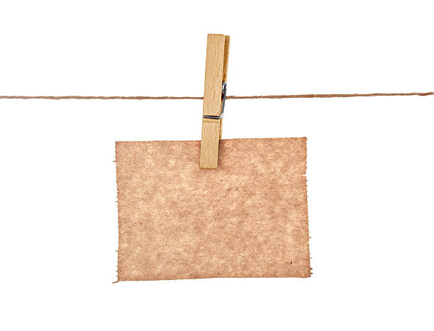 istock kraft paper hang from clothespins on isolated white background 466335264