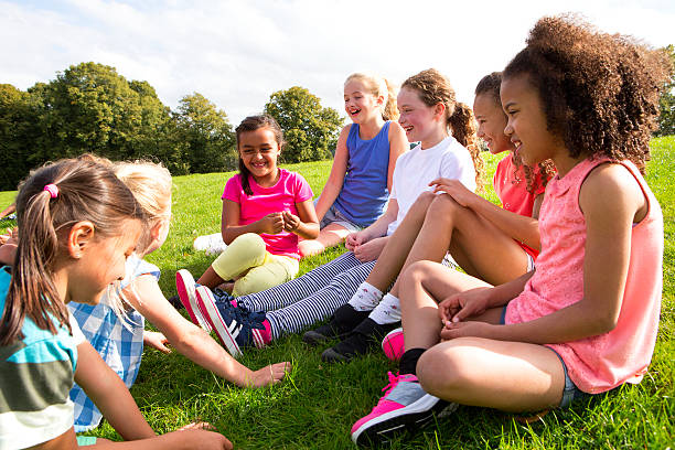 istock Large Group Of Children Sitting on the Grass 466335330