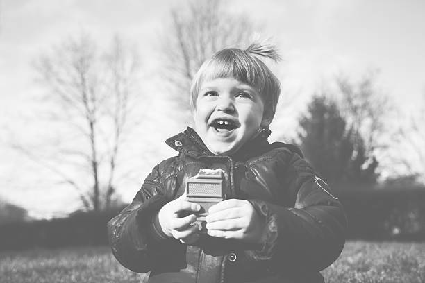 Cheerful little girl eating chocolate.