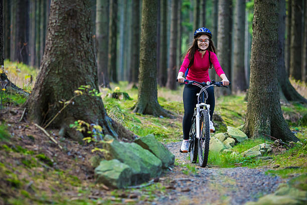 istock Girl riding bike on forest trails 466336654
