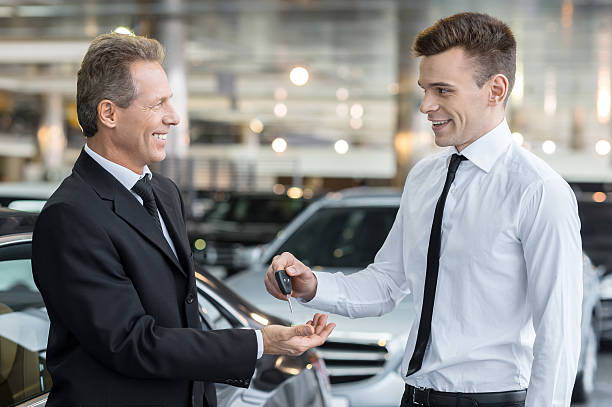istock Giving a key from new car. 466336781