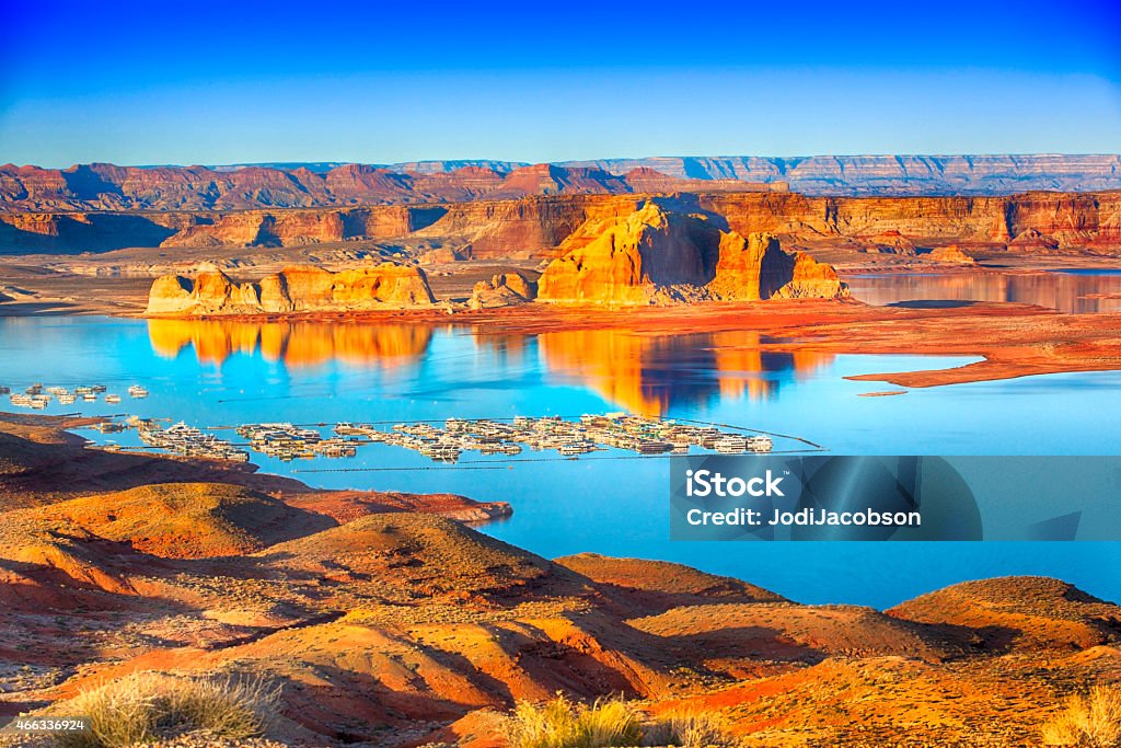 Wahweap Marina Lake Powell Wahweap Marina is situated in Page Arizona near Glen Canyon Dam. The brilliant colors shine at sunset. The crystal clear water reflects the mountainous formations in lake Powell. Shot with a Canon 5D mark 3 Lake Powell Stock Photo