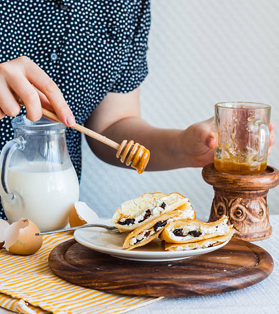 istock thin pancakes stuffed with cheese, prunes, sour cream, add honey 466337418