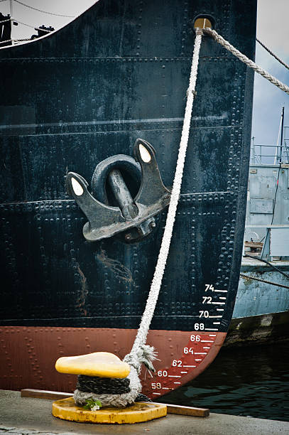 istock Nose of  moored ship with an anchor on a board 466337563