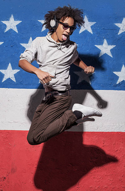 jump ! - grimacing male african descent teenage boys photos et images de collection