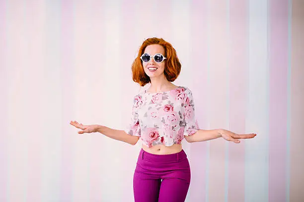 Photo of Young Woman Wearing Sunglasses Dances In Front Of Camera