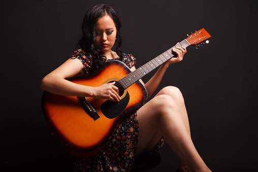 Portrait of asian guitarist woman