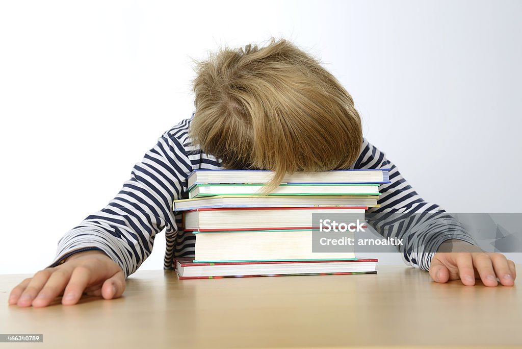 far too much learning boy is sleeping on his books Boys Stock Photo