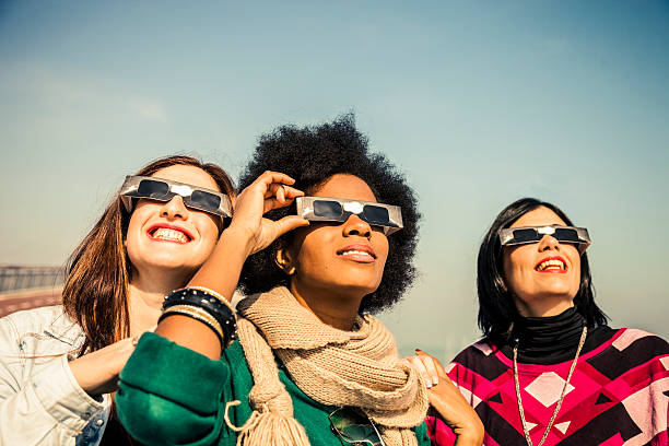 Group of friends looking to a solar eclipse