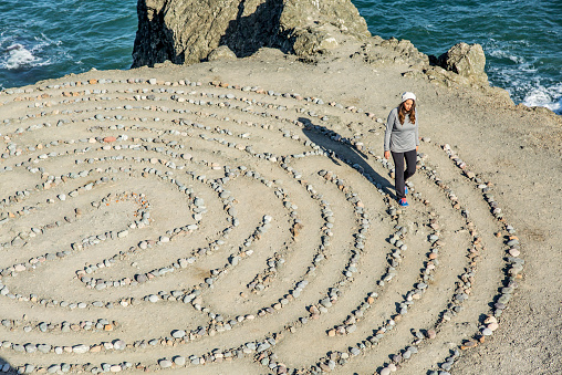 A young attractive Hispanic woman walking the Land's End Eagle Point Labyrinth in San Francisco California
