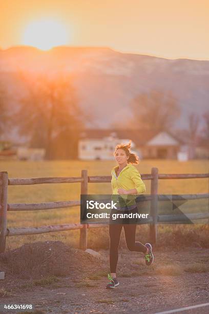 Young Woman In Her 20s Running At Dawn Or Dusk Stock Photo - Download Image Now - 2015, Activity, Adult