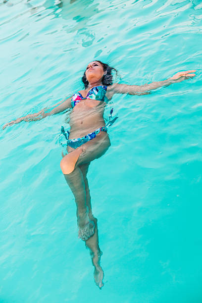 istock Woman relaxes in a pool 466341834
