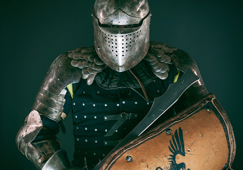 A medieval knights helmet with intricate details and rivets. Perfect for history, war, and reenactment projects, capturing the essence of the medieval era.