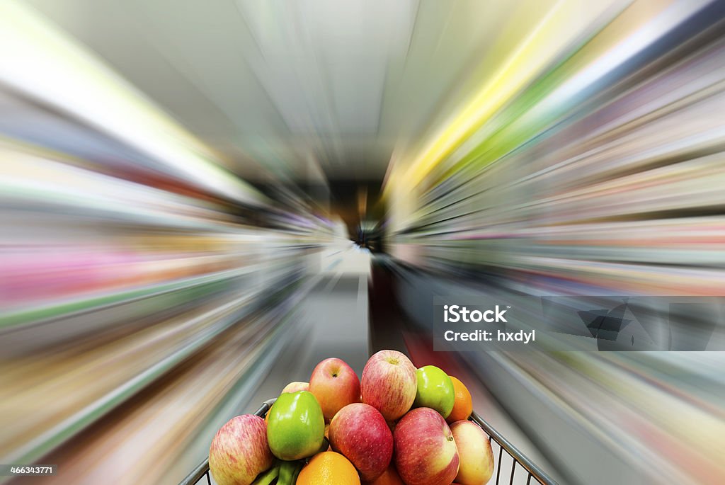 Supermarket Supermarket interior, filled with the fruit of the shopping cart. Aisle Stock Photo