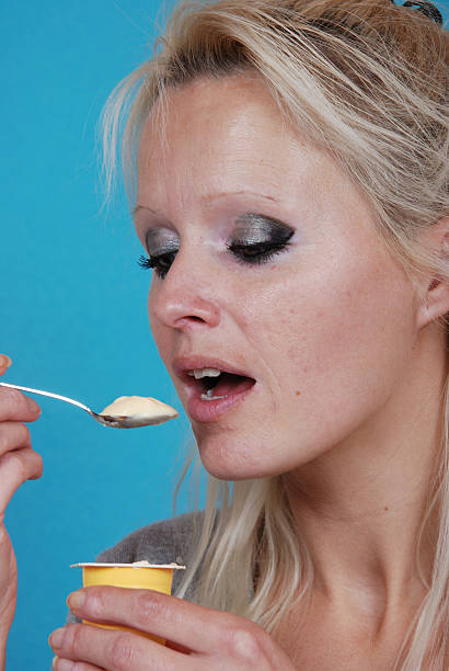 istock young woman eatin cream 466345825