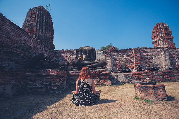 istock Woman meditating in ancient ruins 466345886
