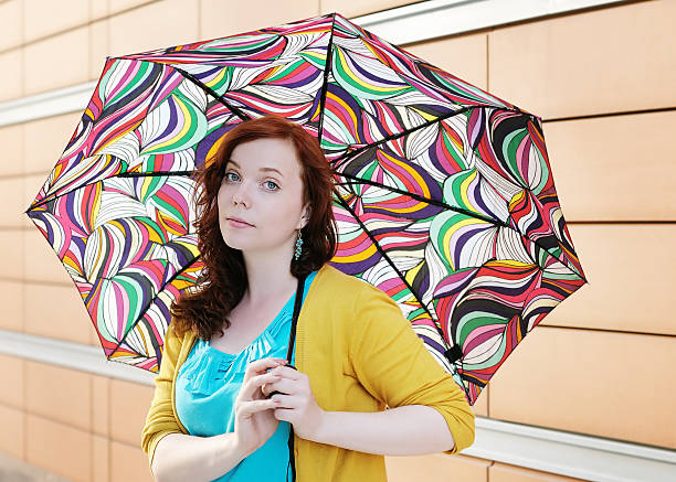 istock Young woman with colorful umbrella 466346163