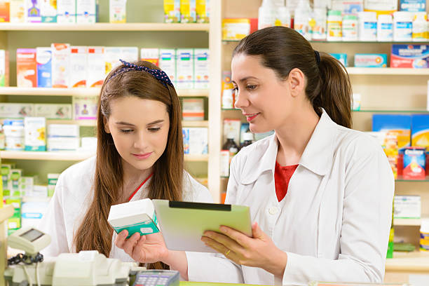 istock Two women working at a pharmacy and looking at medicine 466346408