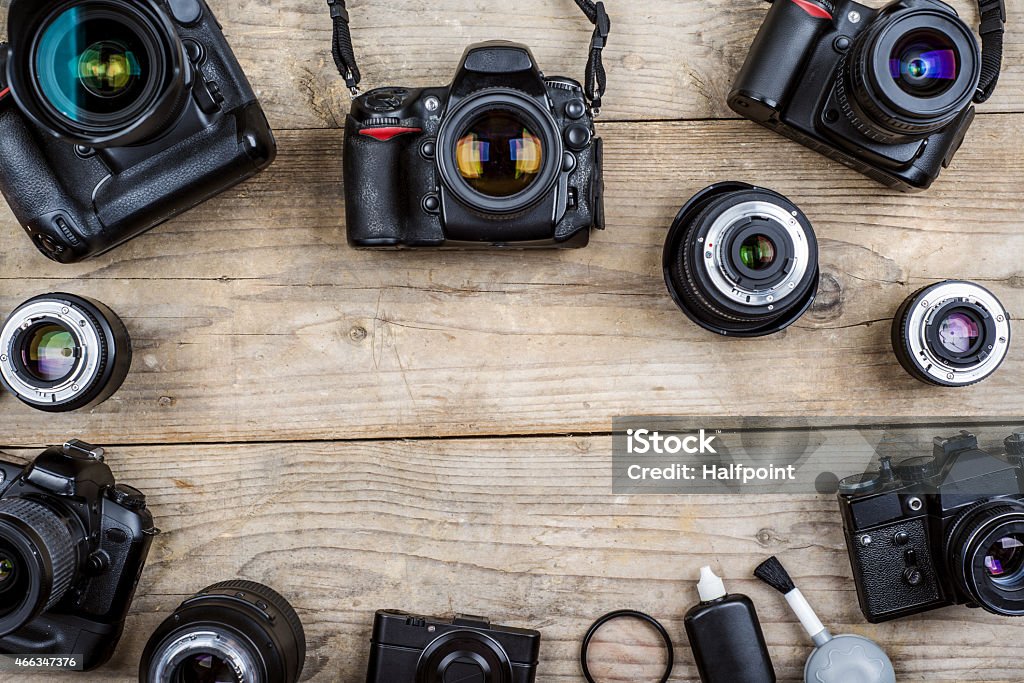 Old cameras Mix of old cameras on wooden desk background. 2015 Stock Photo