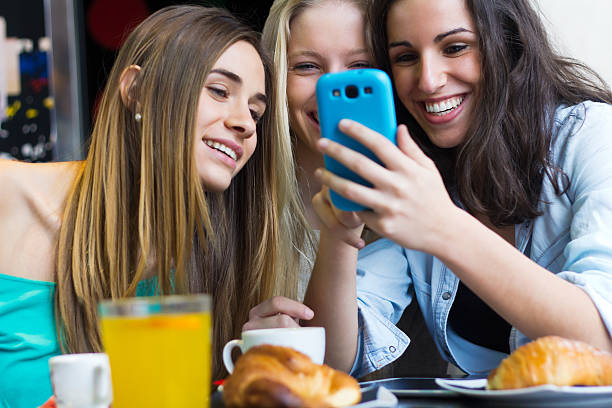istock Friends having fun with smartphones 466348919