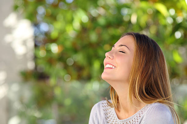 istock Young happy smiling woman doing deep breath exercises 466349407