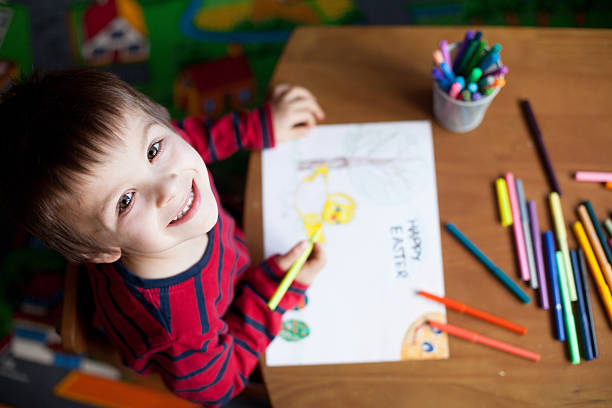 istock Adorable little boy, drawing picture for easter 466350576