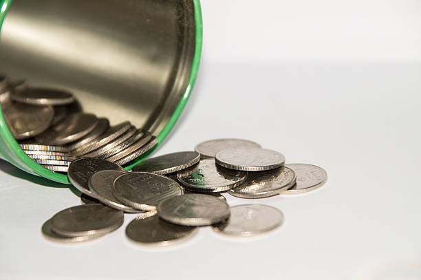 Jar of pennies spilling out stock photo