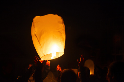 Making a wish with a floating lantern