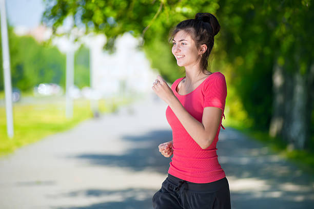 istock Runner - woman running outdoors in green park 466352972