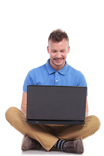 istock seated young man works on laptop 466353818